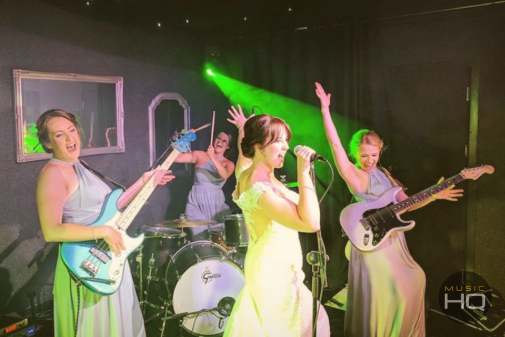 A bridal party posing for a picture with the wedding band