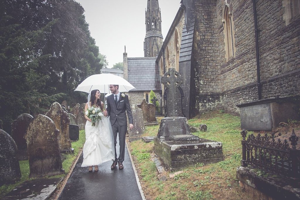 bride and groom in the rain